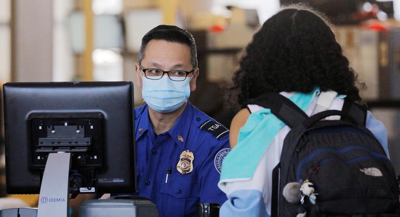 A TSA officer wears a mask at Logan International Airport in Boston.
