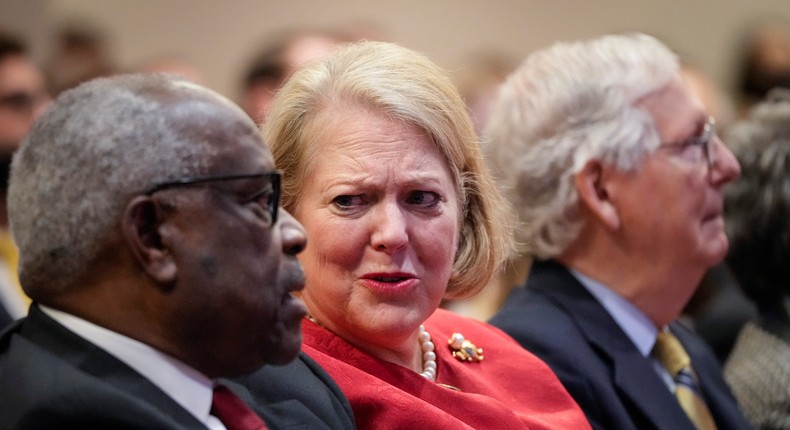 Supreme Court Justice Clarence Thomas sits with his wife, conservative activist Virginia Thomas, while he waits to speak at the Heritage Foundation on October 21, 2021.