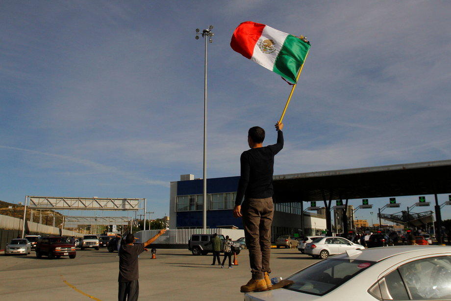 A demonstrator with a Mexican flag during a protest against the rising gas prices in El Chaparral, on the border between the US and Mexico in Tijuana, January 8, 2017.