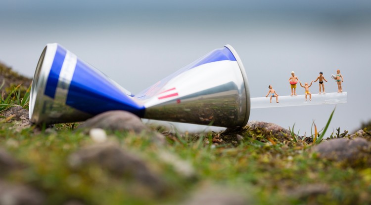 Tiny figurines pictured standing on a plastic pipe