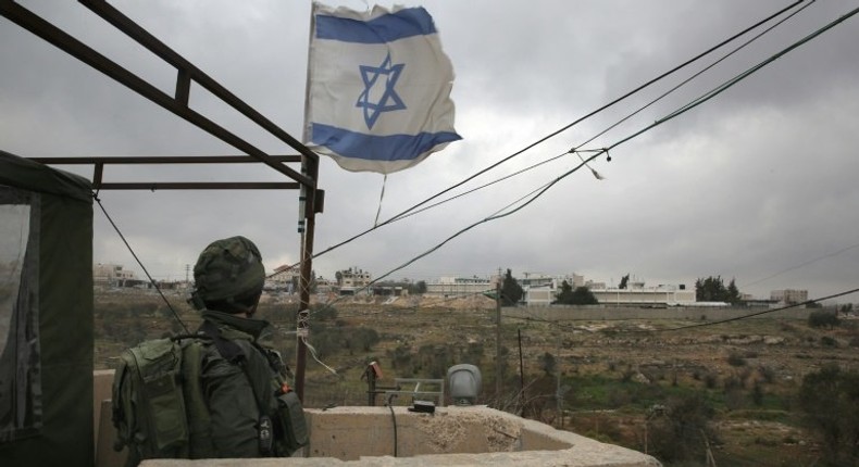 An Israeli soldier stands guard in a monitoring cabin near the West Bank city of Ramallah