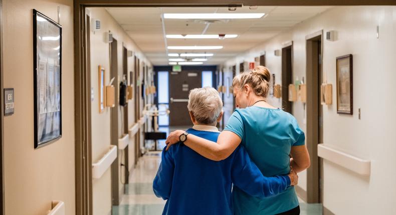 A nurse walks a resident of the assisted living center in Dayton General Hospital in rural Dayton, Washington back to her room. Rural Americans are lacking vital healthcare resources.
