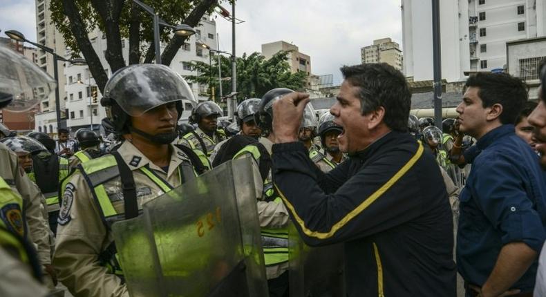 Venezuelan opposition deputy Rafael Guzman (C), confronts National Guard during a protest in front of the National Attorney's General office in Caracas