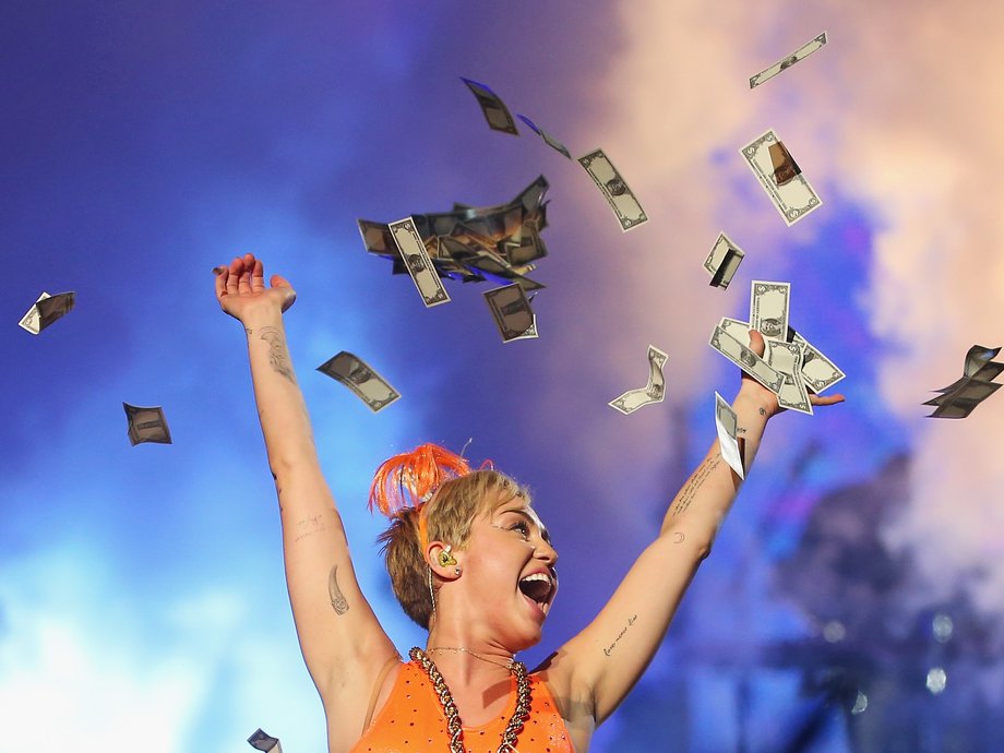 Miley Cyrus throws money in the air as she performs at the opening night of her Bangerz Tour in Australia at Rod Laver Arena on October 10, 2014 in Melbourne, Australia.