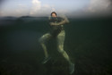 Retired biologist Rosa Cornide swims at the sea in Havana