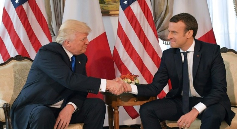 US President Donald Trump (left) and French President Emmanuel Macron shake hands ahead of a working lunch at the US ambassador's residence in Brussels, on May 25, 2017