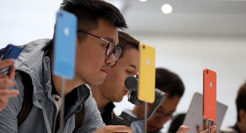 Visitors inspect the new iPhone XR during an Apple special event at the Steve Jobs Theatre on September 12, 2018 in Cupertino, California. Apple released three new versions of the iPhone and an update Apple Watch.