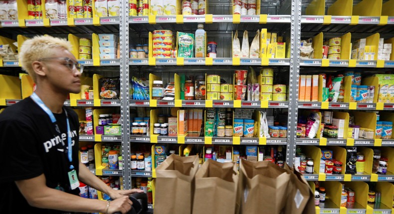 An Amazon worker filling an Amazon Prime Now order.