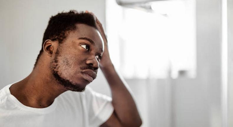 A man looking at himself in the mirror