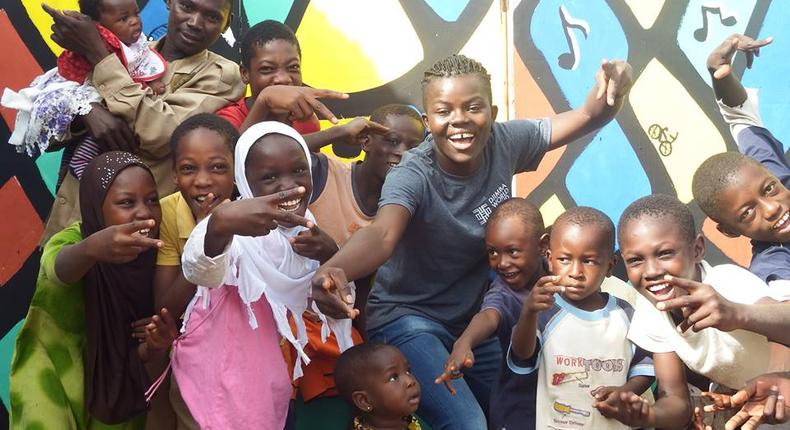 Wiyaala poses for photos at the Djimba World Music Festival venue with kids