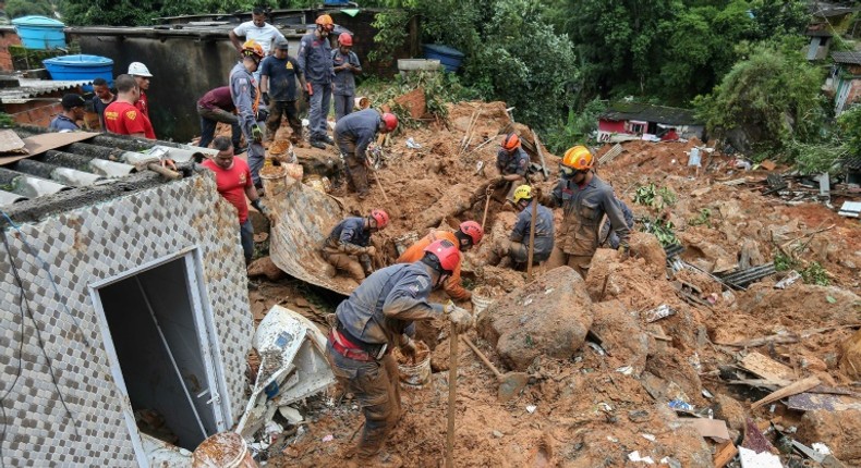 Rescuers search for victims at the Morro do Macaco Molhado favela in the coastal city of Guaruja, Sao Paulo, after it was struck by torrential rains