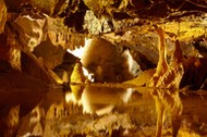 Stalactites and stalagmites reflected in pool, Gough's Cave, Cheddar Caves, Somerset, England, UK