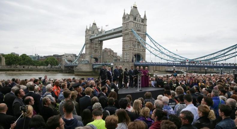 People gather for a vigil in Potters Fields Park, with Tower Bridge in the background, to commemorate the victims of the terror attack on London Bridge and at Borough Market