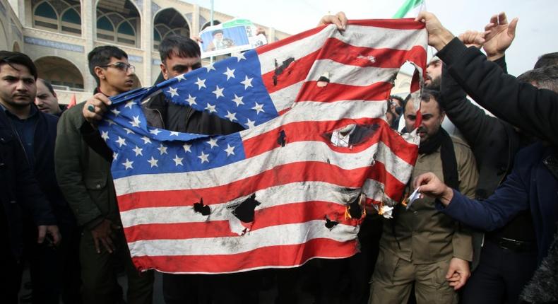 Iranians burn a US flag during a demonstration against American crimes