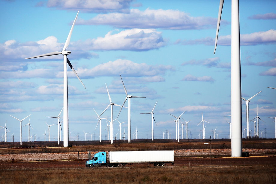 A truck drives past a wind farm in Colorado City, Texas.