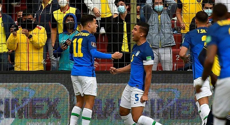 Brazil's Casemiro (right) celebrates with Philippe Coutinho after opening the scoring in their World Cup qualifer against Ecuador Creator: Rodrigo BUENDIA