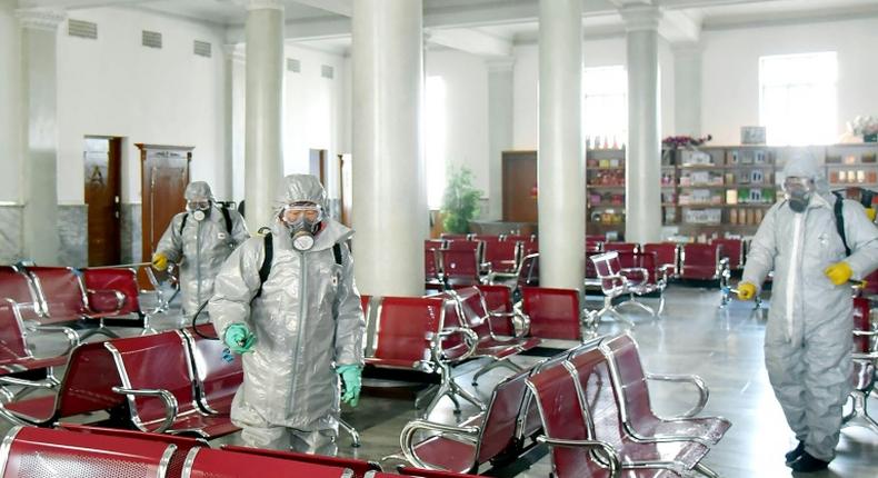 This undated picture released from North Korea's official Korean Central News Agency (KCNA) on February 15, 2020 shows people in protective suits spraying disinfectant at an undisclosed location in North Korea, amid concerns of the COVID-19 outbreak