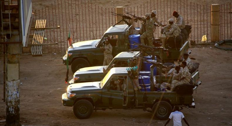 Members of Sudan's intelligence services shoot bullets in the air at the headquarters of the Directorate of General Intelligence Service in the Riyadh district of the capital Khartoum