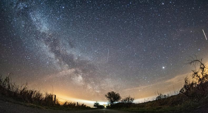 The milky way and meteors of the April Lyrids annual meteor shower in the night sky over the Baltic Sea