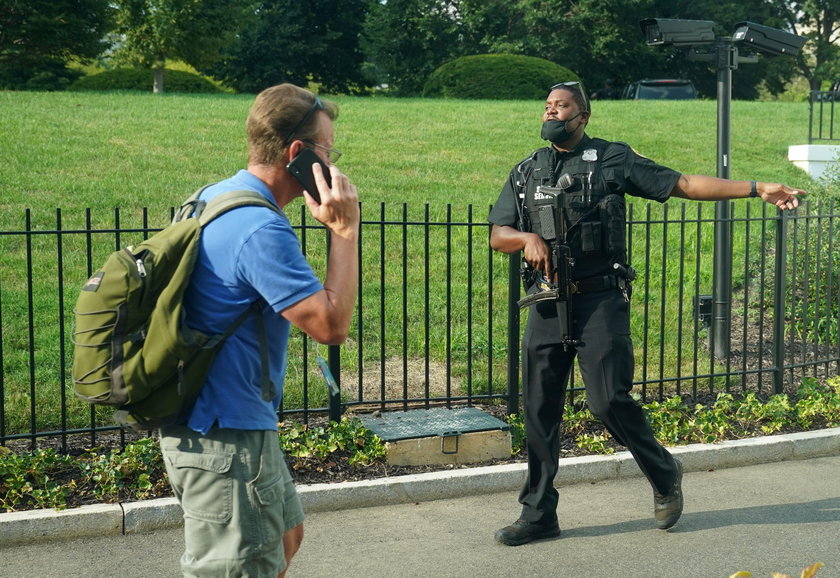Police officers stop a suspect after a shooting incident outside of the White House, in Washington
