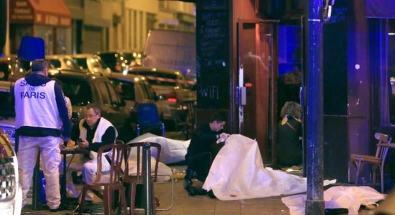  Victims lay on the pavement outside a Paris restaurant, Friday, Nov. 13, 2015. Police officials in France on Friday report multiple terror incidents, leaving many dead. It was unclear at this stage if the events are linked.