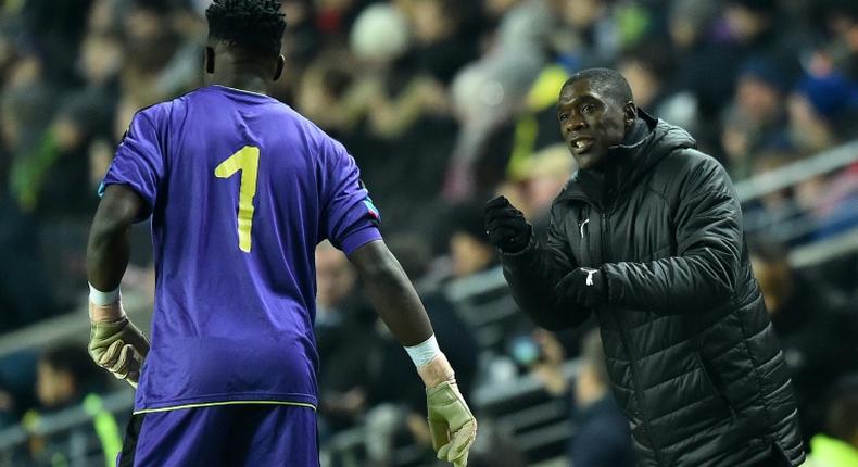 Cameroon coach Clarence Seedorf instructs goalkeeper Andre Onana during a 1-0 friendly loss to Brazil in England last November