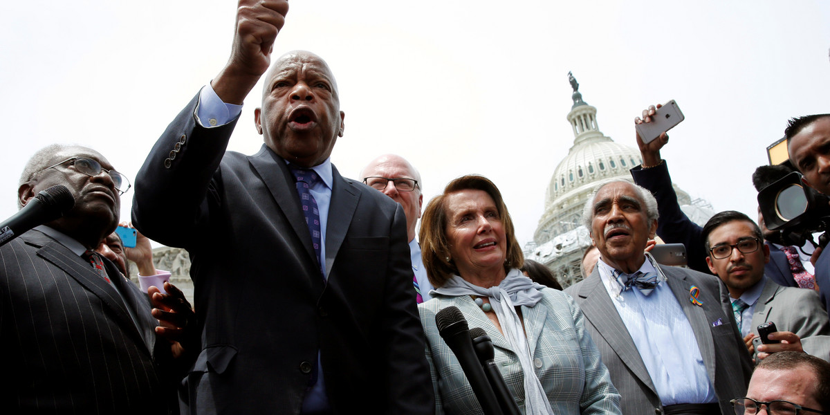US Rep. John Lewis (second from left) talks to supporters along with House Democrats after their sit-in over gun control on Capitol Hill in Washington, DC, on June 23.