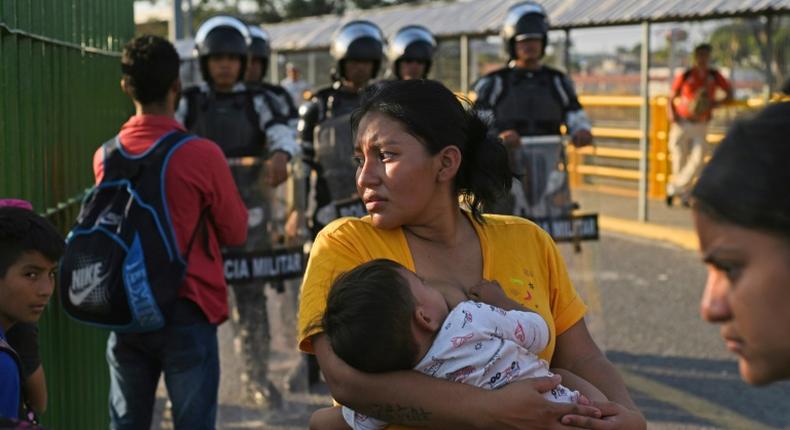 Honduran migrants wait to cross the international border bridge from Ciudad Tecun Uman in Guatemala to Ciudad Hidalgo in Mexico in January 2020