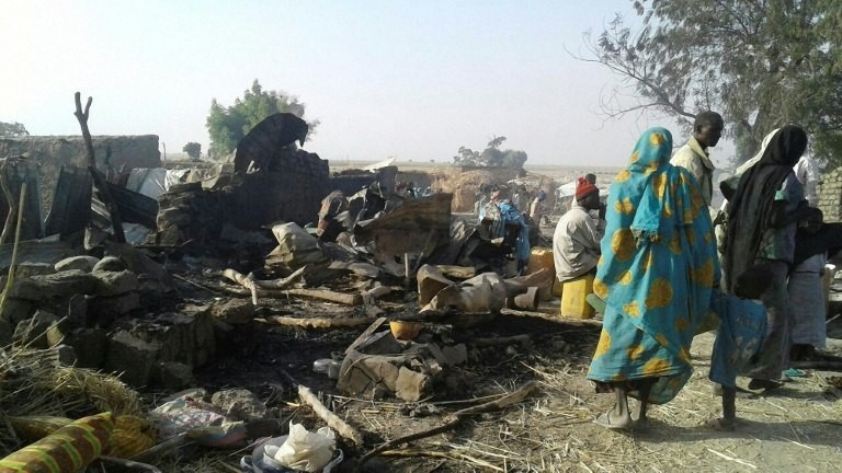 Survivors look at the aftermath of the bombing by the Nigerian air force of a camp for displaced people in Rann, northeast Nigeria, on January 17, 2017. (AFP) 