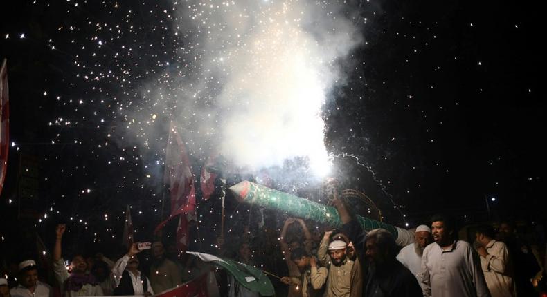 Pakistanis in Karachi celebrate the shooting down of two Indian fighter jets by the Pakistan Air Force