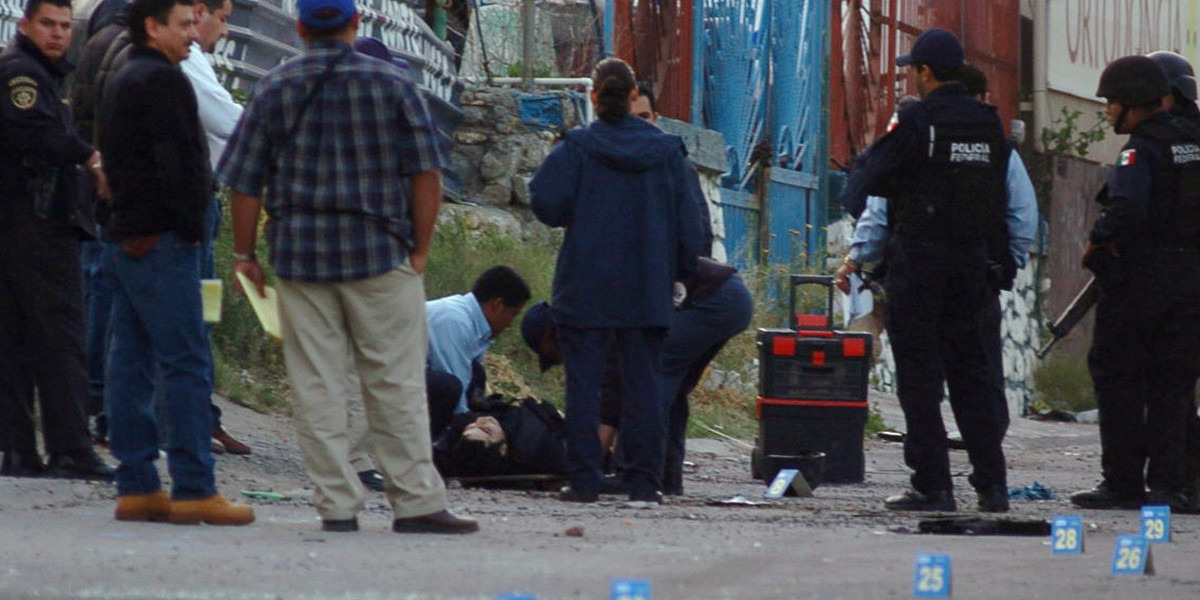 Forensic officers and policemen work in the area where 15 men were killed in one of the deadliest shootouts in Mexico's then three-year-old narco-war, Tijuana, April 26, 2008.