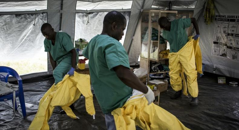 A team of medical workers are seen putting on their Personal Protective Equipment (PPE) ahead of entering an Ebola Treatment Centre run by The Alliance for International Medical Action (ALIMA) on August 11, 2018 in Beni, northeastern DRC