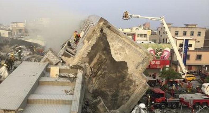 Rescue personnel work on damaged buildings after an earthquake in Tainan, southern Taiwan, February 6, 2016.