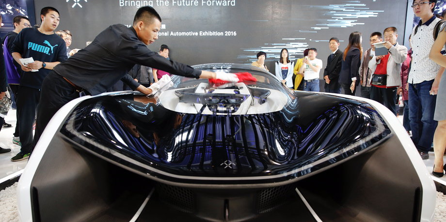 Visitors gather around the Faraday Future FFZERO1 electric concept car during the Auto China 2016 auto show in Beijing, China, April 29, 2016.