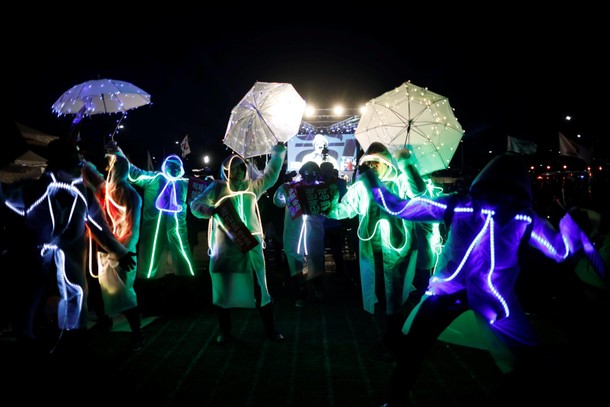 People decorated with LED bulbs perform during a rally calling for impeached President Park Geun-hye