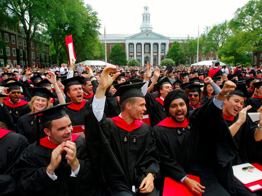 Students cheer at the Harvard Business School graduation ceremony.