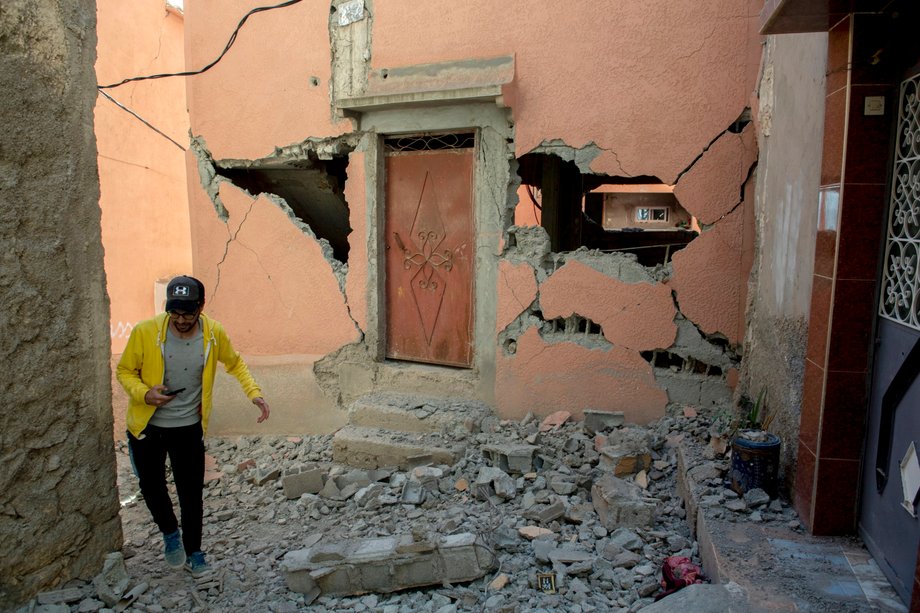 A man walks through rubble next to a damaged building after the earthquake that struck Marrakesh, Morocco, September 9, 2023.