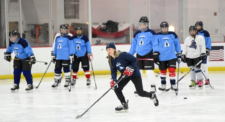 US hockey player Haley Skarupa, front, demonstrates a drill during a hockey clinic presented by the Washington Capitals and the PWHPA.AP Photo/Nick Wass