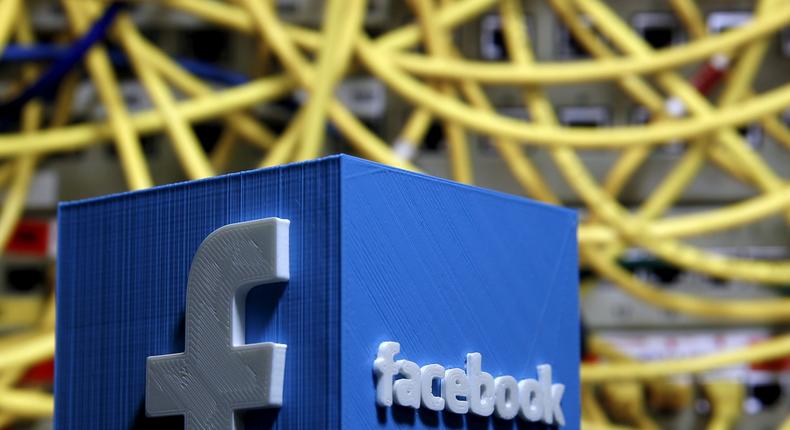 FILE PHOTO: A 3D plastic representation of the Facebook logo is seen in front of displayed cables in this illustration in Zenica, Bosnia and Herzegovina May 13, 2015. REUTERS/Dado Ruvic/File Photo