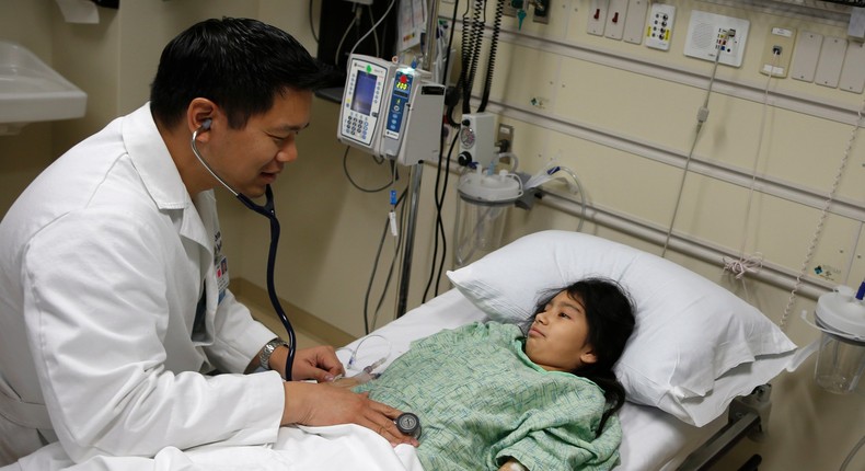 Patient Analy Navarro being checked by Doctor Leon Yeh in the emergency room at OSF Saint Francis Medical Center in Peoria, Illinois, in 2013.