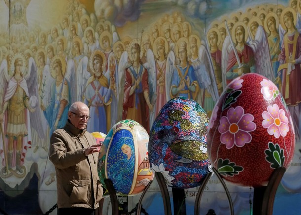 Man looks at traditional Ukrainian Easter egg Pysanka, displayed at square, as part of upcoming Ea