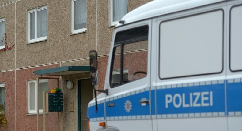 A police vehicle stands in front of a house in Suhl, east Germany, during an anti-terror operation on October 25, 2016