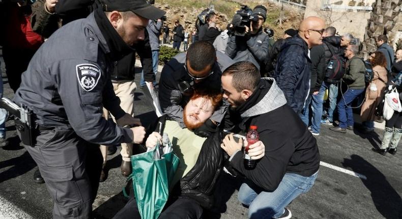 Israeli police detain a demonstrator during a protest outside the defence ministry in Tel Aviv on January 4, 2017, in support of Israeli soldier Elor Azaria