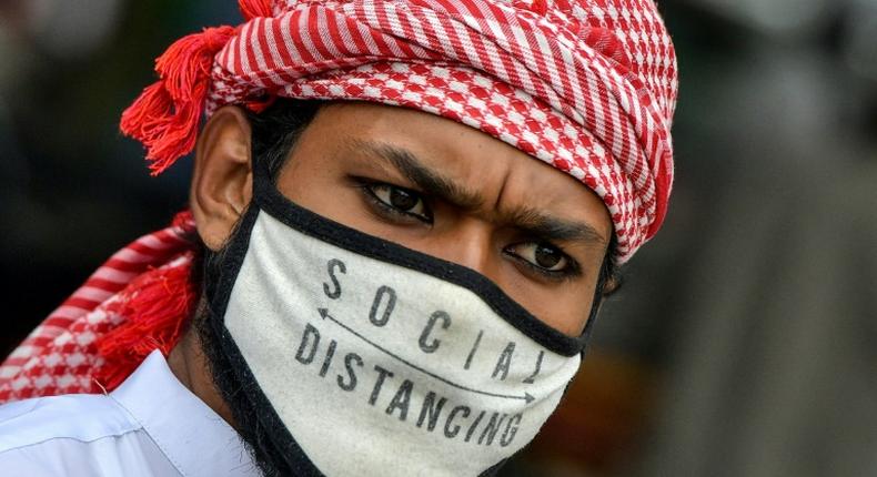 A Muslim wearing a face mask comes out of Masjid-e-Eidgah Bilal after offering prayers during the Eid al-Adha, the feast of sacrifice, in Bangalore on August 1, 2020.