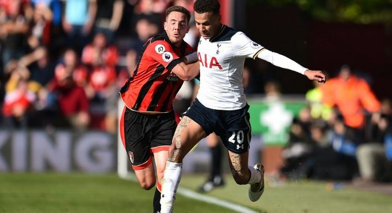 Bournemouth's English midfielder Dan Gosling (L) grapples with Tottenham's English midfielder Dele Alli during the Premier League match at the Vitality Stadium in Bournemouth, southern England on October 22, 2016