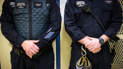 Corrections officers work in the Enhanced Supervision Housing Unit at the Rikers Island Correctional