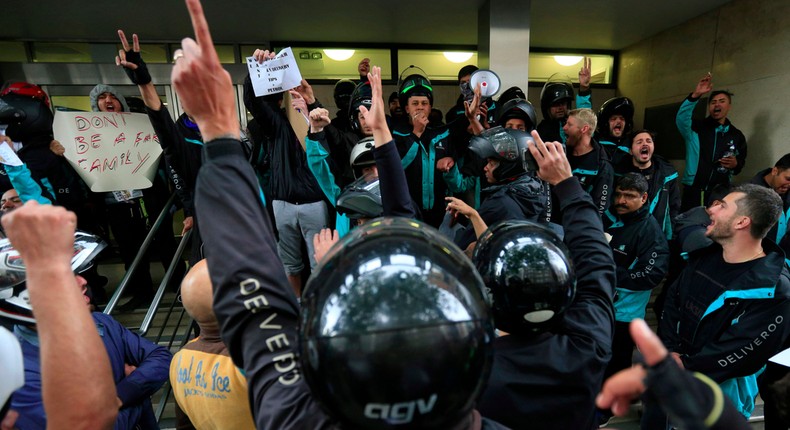 Deliveroo riders hold a protest over pay outside the company HQ in Torrington Place, London, in August 2016.