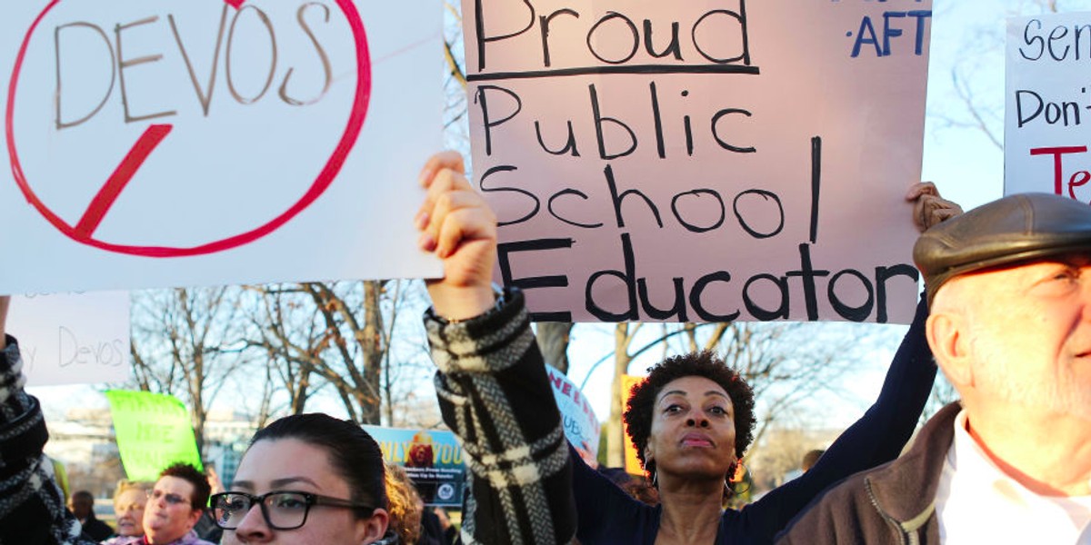 Protesters demonstrate against DeVos, President Donald Trump's nominee for secretary of education, on Monday in Washington, DC.