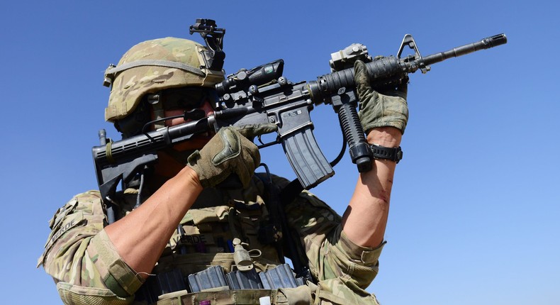 A US Army soldier attached to 2nd platoon, C troop, 1st Squadron (Airborne), 91st U.S Cavalry Regiment, 173rd Airborne Brigade Combat Team operating under the International Security Assistance Force (ISAF) looks through his rifle during a patrol near Baraki Barak base in Logar Province, on October 10, 2012.
