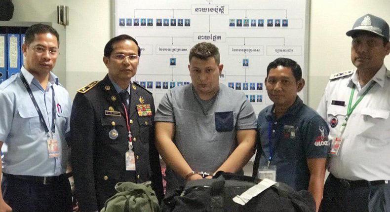 A Romanian, Narcis-Manuel Olaru (center), was arrested with 11 pounds of methamphetamine and led Cambodian Police to his three Nigerian accomplices and a fellow Romanian